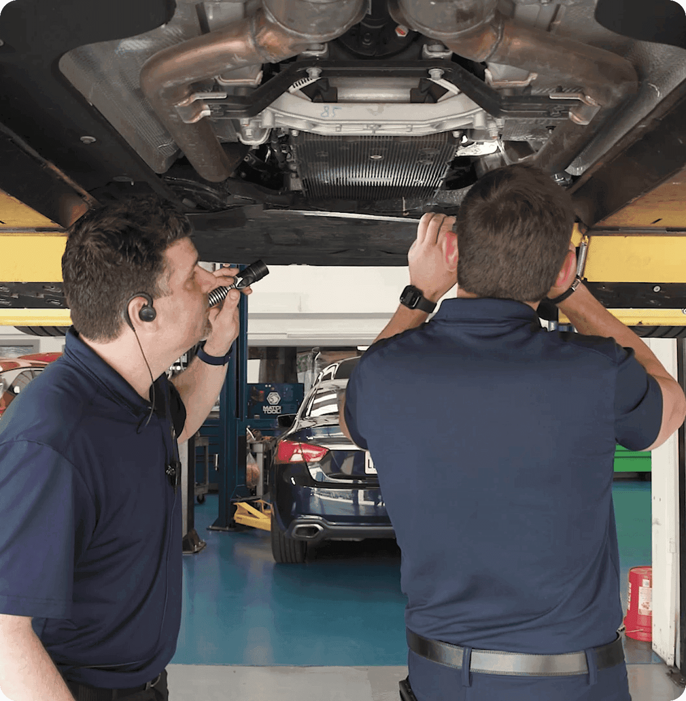A mechanic working in a clean, modern service garage